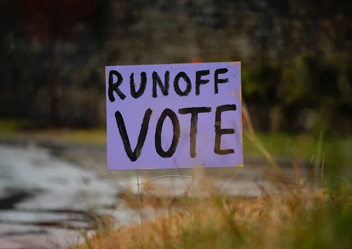 A sign encourages people to vote the day before the midterm runoff election in Atlanta, Georgia, U.S., December 5, 2022. REUTERS/Cheney Orr