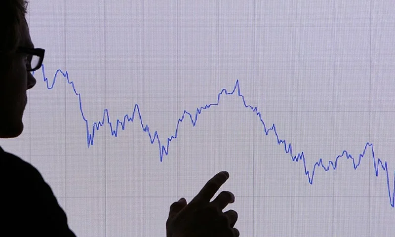 LONDON - OCTOBER 07: In this photo illustration, a man looks at a graph representing the 12 month decline of the FTSE 100 share index on October 7, 2008 in London. Financial markets are still suffering large losses as the global banking crisis continued. (Photo by Peter Macdiarmid/Getty Images)