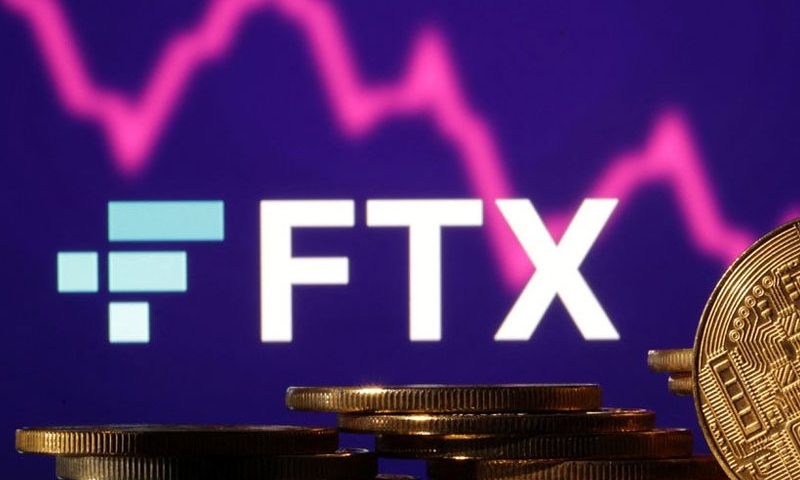 FILE PHOTO: Illustration shows FTX logo, stock graph and representation of cryptocurrencies
