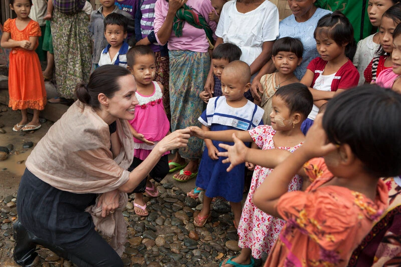 : In this handout photo provided by the Maddox Jolie-Pitt Foundation, actress and activist Angelina Jolie Pitt meets children during a visit to Ja Mai Kaung Baptist refugee camp on July 30, 2015 in Myitkyina, Myanmar. Angelina Jolie Pitt is a Special Envoy of UN High Commissioner for Refugees since her 2012 appointment. (Photo by Tom Stoddart/Getty Images Reportage/Maddox Jolie-Pitt Foundation via Getty Images)