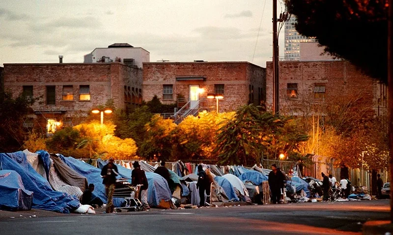 Night falls on a "crack alley", so-called for its 24-hour drug trading, especially in cheap crack cocaine, December 11, 2000 in Los Angeles, CA. Non-paying strangers are met with great suspicion by homeless gang members. (Photo by David McNew/Newsmakers)