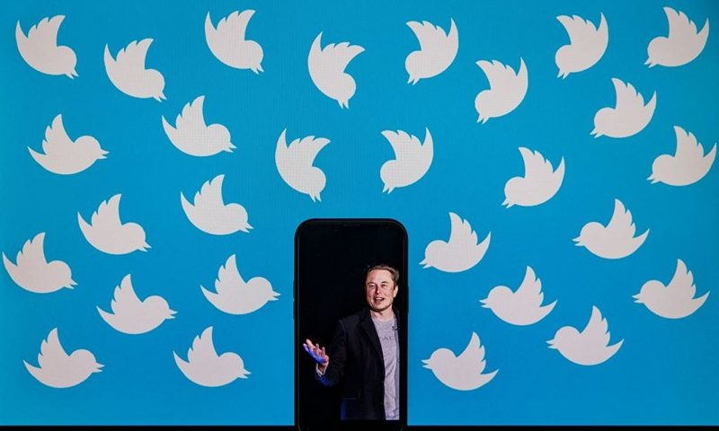 This illustration photo taken on August 5, 2022 shows a cellphone displaying a photo of Elon Musk placed on a computer monitor filled with Twitter logos in Washington, DC. - Elon Musk has accused Twitter of fraud, alleging the social media platform misled him about key aspects of its business before he agreed to a $44 billion buyout, as their court battle heats up. (Photo by SAMUEL CORUM / AFP) (Photo by SAMUEL CORUM/AFP via Getty Images)