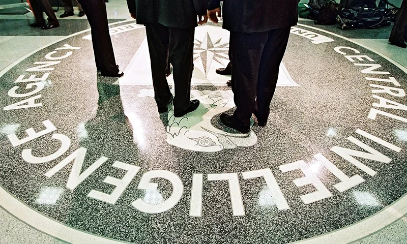 President George W. Bush, Central Intelligence Agency Director George Tenet and others stand on the seal of the Agency March 20, 2001 at the CIA Headquarters in Langley, Virginia. Bush toured the facility and met some of the Agency''s employees. (Pool Photo by David Burnett/Newsmakers)