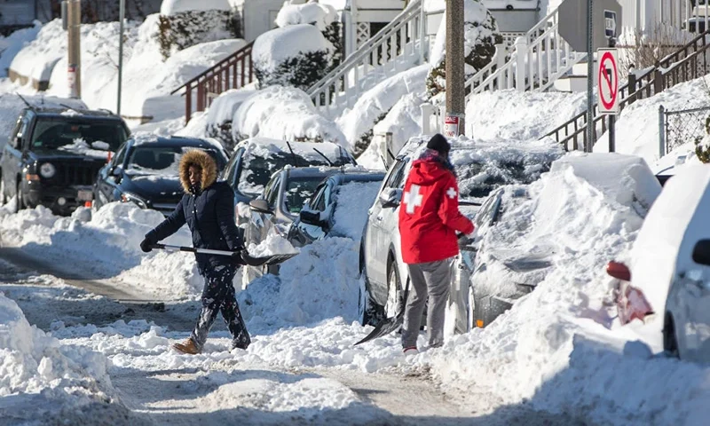 Residents shovel out their vehicle the day after the region was hit with a "bomb cyclone" on January 5, 2018 in the Dorchester neighborhood of Boston, Massachusetts. Schools and businesses throughout the Boston area get back to work today after the city received over a foot of snow during the fast moving storm yesterday. (Photo by Scott Eisen/Getty Images)
