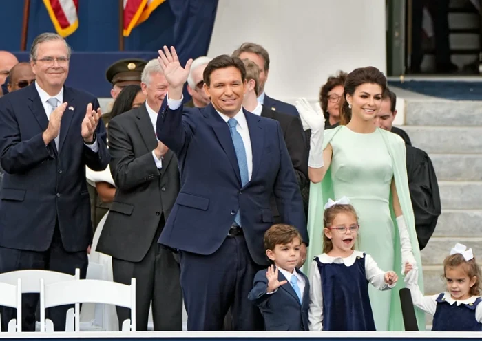 Florida Gov. Ron DeSantis, center, waves as he arrives with his wife Casey, right, and their children Mason, Madison, and Mamie before his inauguration ceremony outside the Old Capitol Tuesday, Jan. 3, 2023, in Tallahassee, Fla. Applauding at a left is former governor Jeb Bush. (AP Photo/Lynne Sladky).