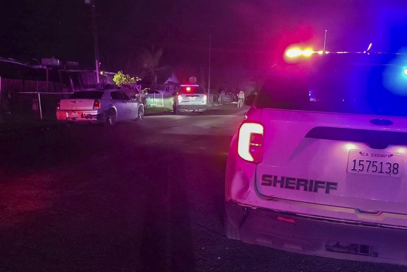 In this image released by Tulare County Sheriff's Office, detectives investigate a shooting in Goshen near Visalia, Calif., early morning Monday, Jan. 16, 2023. Sheriff's officials say six people including a 17-year-old mother and her 6-month-old baby were killed in a shooting early Monday at the home in central California, and authorities are searching for at least two suspects. (Tulare County Sheriff's Office via AP)