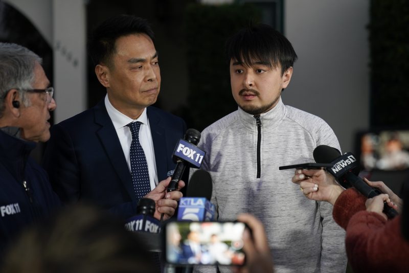 Brandon Tsay, 26, right, and his father, Tom Tsay, make a statement outside their home on Monday, Jan. 23, 2023, in San Marino, Calif. Brandon Tsay disarmed a gunman who killed multiple people late Saturday amid Lunar New Years celebrations in the predominantly Asian American community. The gunman started at the Star Ballroom Dance Studio in Monterey Park and continued to Lai Lai Ballroom and Studio in Alhambra, where he was disarmed by Tsay. (AP Photo/Ashley Landis)