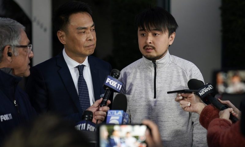 Brandon Tsay, 26, right, and his father, Tom Tsay, make a statement outside their home on Monday, Jan. 23, 2023, in San Marino, Calif. Brandon Tsay disarmed a gunman who killed multiple people late Saturday amid Lunar New Years celebrations in the predominantly Asian American community. The gunman started at the Star Ballroom Dance Studio in Monterey Park and continued to Lai Lai Ballroom and Studio in Alhambra, where he was disarmed by Tsay. (AP Photo/Ashley Landis)