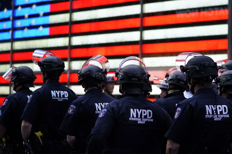 OPSHOT - NYPD police officers watch demonstrators in Times Square on June 1, 2020, during a "Black Lives Matter" protest. - New York's mayor Bill de Blasio today declared a city curfew from 11:00 pm to 5:00 am, as sometimes violent anti-racism protests roil communities nationwide.
Saying that "we support peaceful protest," De Blasio tweeted he had made the decision in consultation with the state's governor Andrew Cuomo, following the lead of many large US cities that instituted curfews in a bid to clamp down on violence and looting. (Photo by TIMOTHY A. CLARY / AFP) (Photo by TIMOTHY A. CLARY/AFP via Getty Images)