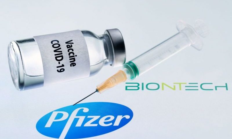 his illustration picture taken on November 23, 2020 shows a bottle reading "Vaccine Covid-19" and a syringe next to the Pfizer and Biontech logo. - The European Commission has signed five contracts to pre-order vaccines, among which with the U.S.-German company Pfizer-BioNTech (up to 300 million doses). (Photo by JOEL SAGET / AFP) (Photo by JOEL SAGET/AFP via Getty Images)