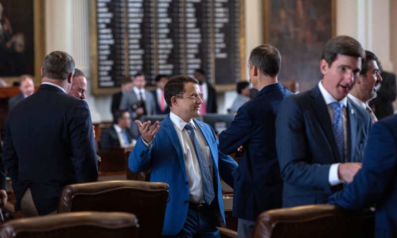 Texas state Rep. Briscoe Cain, R-Deer Park, talks with fellow state representatives in the House chamber on the first day of the 87th Legislature's special session at the State Capitol on July 8, 2021 in Austin, Texas. Republican Gov. Greg Abbott called the legislature into a special session, asking lawmakers to prioritize his agenda items that include overhauling the states voting laws, bail reform, border security, social media censorship, and critical race theory. (Photo by Tamir Kalifa/Getty Images)