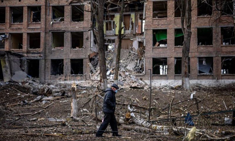 TOPSHOT - A man walks in front of a destroyed building after a Russian missile attack in the town of Vasylkiv, near Kyiv, on February 27, 2022. - Ukraine's foreign minister said on February 27, that Kyiv would not buckle at talks with Russia over its invasion, accusing President Vladimir Putin of seeking to increase "pressure" by ordering his nuclear forces on high alert. (Photo by Dimitar DILKOFF / AFP) (Photo by DIMITAR DILKOFF/AFP via Getty Images)