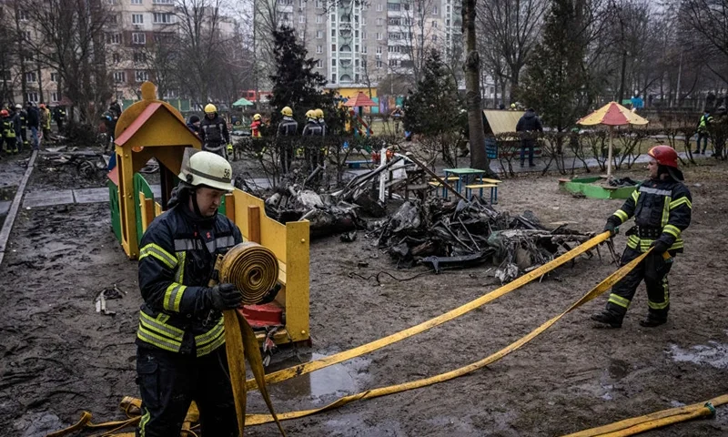 BROVARY, UKRAINE - JANUARY 18: Firemen roll up hoses in front of debris as emergency service workers respond at the site of a helicopter crash on January 18, 2023 in Brovary, Ukraine. Eighteen people have been killed, including Ukraine's interior affairs minister Denys Monastyrsky along with eight other helicopter passengers, after they crashed near a nursery in a Kyiv suburb. (Photo by Ed Ram/Getty Images)