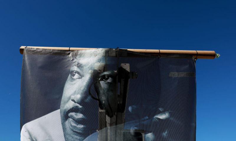 An image of Dr. Martin Luther King Jr. hangs on the back of a sanitation department truck during the Dr. Martin Luther King Jr. Day Parade in the Liberty City neighborhood on January 16, 2023 in Miami, Florida. The annual event honors the late civil rights leader. (Photo by Joe Raedle/Getty Images)