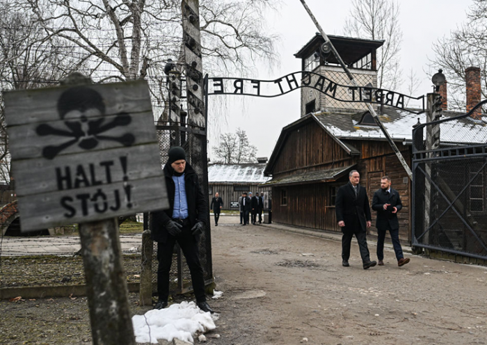 U.S. Second Gentleman, Douglas Emhoff (2R), walks past the main gate of the former Auschwitz Concentration Camp during the Holocaust Remembrance Day at the former Auschwitz I site on January 27, 2023 in Oswiecim, Poland. International Holocaust Remembrance Day, 27 January, is observed on the anniversary of the liberation of Auschwitz-Birkenau, the largest Nazi death camp. (Photo by Omar Marques/Getty Images)