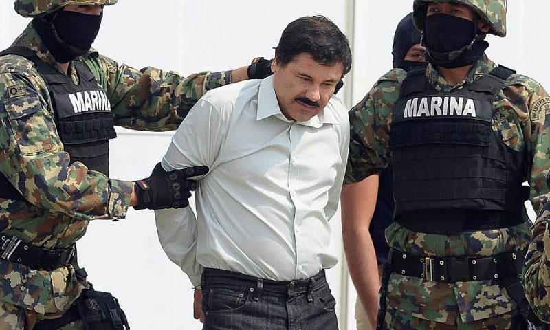 Mexican drug trafficker Joaquin Guzman Loera aka "el Chapo Guzman" (C), is escorted by marines as he is presented to the press on February 22, 2014 in Mexico City. Mexican drug lord Joaquin "El Chapo" Guzman has escaped from a maximum-security prison for the second time in 14 years, sparking a massive manhunt Sunday and dealing an embarrassing blow to the government. AFP PHOTO/Alfredo Estrella (Photo credit should read ALFREDO ESTRELLA/AFP via Getty Images)