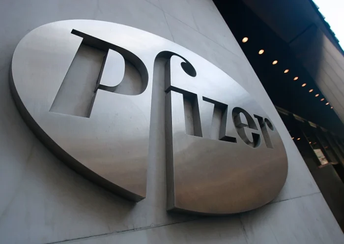 NEW YORK - JANUARY 26: A Pfizer sign hangs on the outside of their headquarters after a news conference discussing the planned merger of Pfizer and Wyeth January 26, 2009 in New York City. Pfizer plans to acquire Wyeth for $68 billion creating the world's largest biopharmaceutical company. (Photo by Mario Tama/Getty Images)