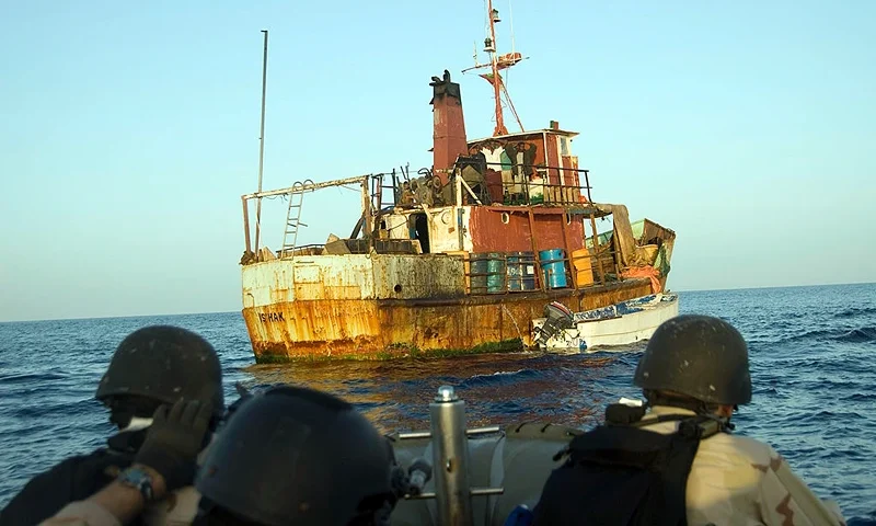 In this handout from the U.S. Navy, members of a boarding team from the guided-missile cruiser USS Gettysburg (CG 64) and U.S. Coast Tactical Law Enforcement Team South, Detachment 409, approach suspected pirates aboard a ship May 13, 2009 in the Gulf of Aden.