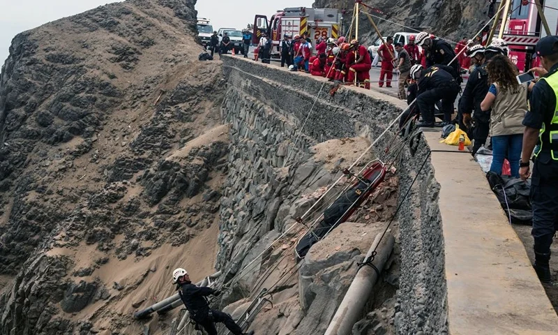 Rescuers, police and firefighters work at the scene after a bus plunged the day before around 100 meters over a cliff when it collided with a truck on a coastal highway near Pasamayo, around 45 km north of Lima, killing 48 people, on January 3, 2018. The bus was travelling from Huacho, 130 km north of the capital, to Lima with 53 passengers on board. The spot where the accident occurred is known as the "devil's curve." / AFP PHOTO / Ernesto BENAVIDES (Photo credit should read ERNESTO BENAVIDES/AFP via Getty Images)
