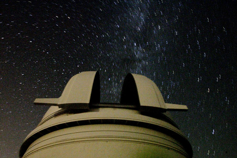 View of the Palomar Observatory at night, on August 28, 2006, outside of San Diego, California. Scientists at the obsevatory were instrumental in determining that Pluto be downgraded to a dwarf planet. (Photo by Sandy Huffaker/Getty Images)