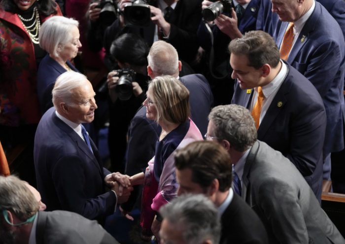 President Joe Biden arrives to deliver the State of the Union address to a joint session of Congress at the U.S. Capitol, Tuesday, Feb. 7, 2023, in Washington. Rep. George Santos, R-N.Y., is at right. (AP Photo/Patrick Semansky)