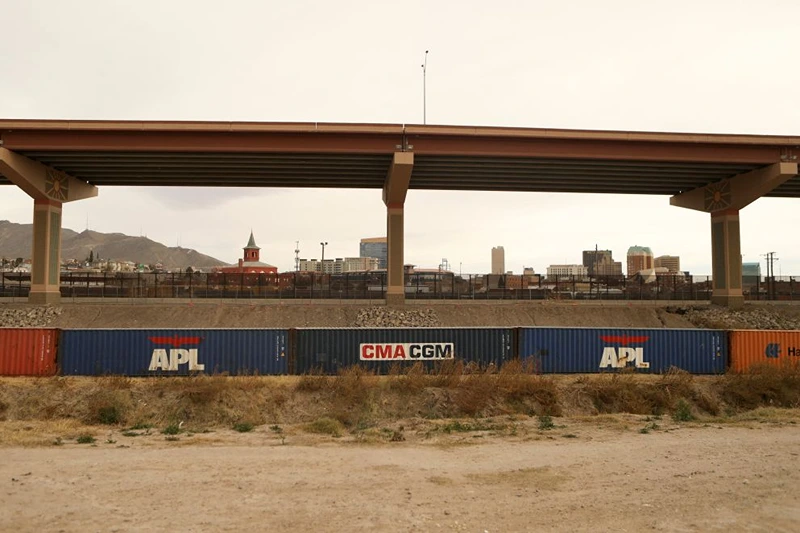 View of cargo containers placed by the United States authorities as a retaining wall on the banks of the Rio Grande in Ciudad Juarez, Chihuahua state, Mexico, taken on December 28, 2022. - The US government's two-year-old policy of invoking Covid-19 precautions to turn away hundreds of thousands of migrants at the Mexican border will remain in place for now, the Supreme Court ruled Tuesday. The decision to uphold the controversial rule known as Title 42 stemmed off a looming political crisis for President Joe Biden, as thousands waited at the southern border in expectation the policy was about to end. (Photo by HERIKA MARTINEZ / AFP) (Photo by HERIKA MARTINEZ/AFP via Getty Images)