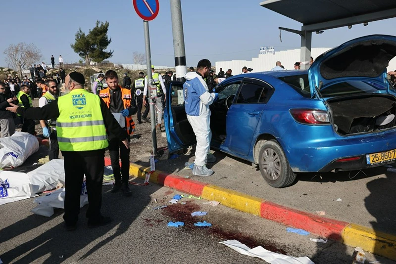 Israeli emergency responders gather at the site of a reported ramming attack in Jerusalem on February 10, 2023. - Six people, including two children, were injured when a car crashed into a bus stop in east Jerusalem, Israeli medics said, in what police called a "suspected ramming attack". (Photo by AHMAD GHARABLI / AFP) (Photo by AHMAD GHARABLI/AFP via Getty Images)
