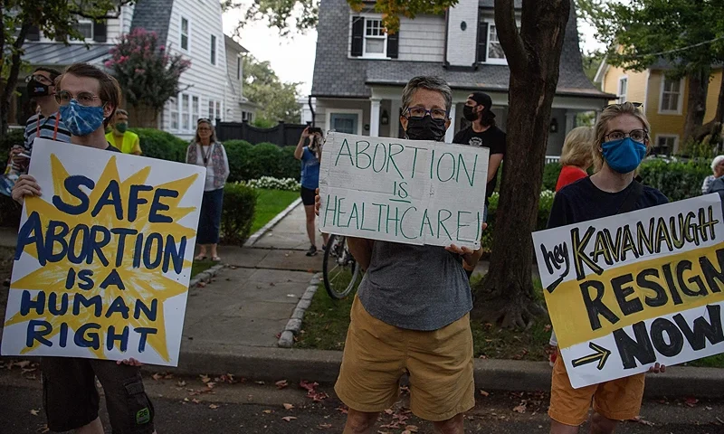 Abortion rights activists protest outside the house of US Supreme Court Justice Brett Kavanaugh in Chevy Chase Maryland, on September 13, 2021, following the court's decision to uphold a stringent abortion law in Texas (Photo by Nicholas Kamm / AFP) (Photo by NICHOLAS KAMM/AFP via Getty Images)