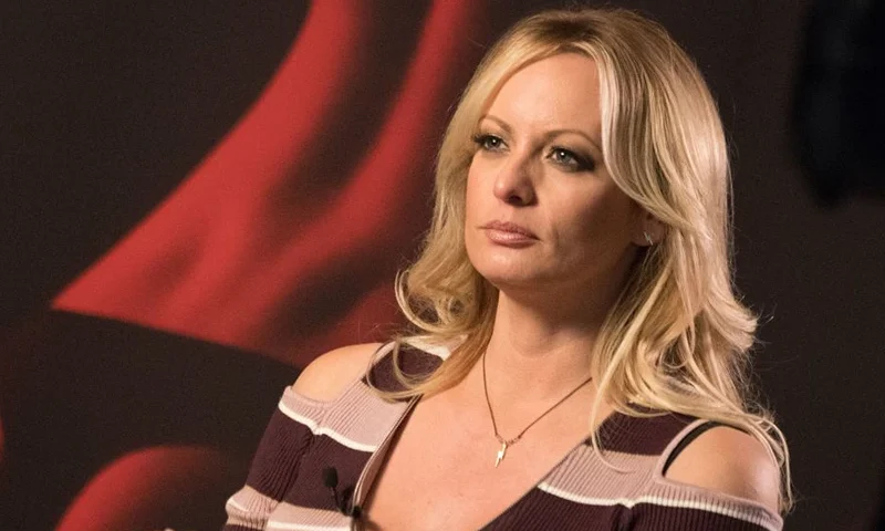 Stormy Daniels, the porn star who claims to have slept with US President Donald Trump over a decade ago, talks with a journalist during an interview at the Berlin erotic fair "Venus" in Berlin on October 11, 2018. (Photo by Ralf Hirschberger / dpa / AFP) / Germany OUT (Photo credit should read RALF HIRSCHBERGER/DPA/AFP via Getty Images)