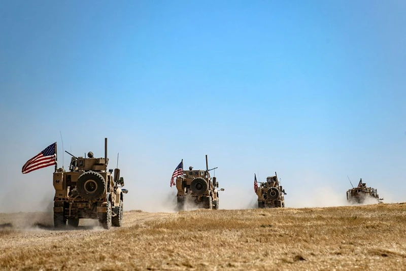 A US military convoy takes part in joint patrol with Turkish troops in the Syrian village of al-Hashisha on the outskirts of Tal Abyad town along the border with Turkish troops, on September 8, 2019. - The United States and Turkey began joint patrols in northeastern Syria aimed at easing tensions between Ankara and US-backed Kurdish forces. Six Turkish armoured vehicles crossed the border to join US troops in Syria for their first joint patrol under a deal reached between Washington and Ankara, an AFP journalist reported. (Photo by Delil SOULEIMAN / AFP) (Photo by DELIL SOULEIMAN/AFP via Getty Images)
