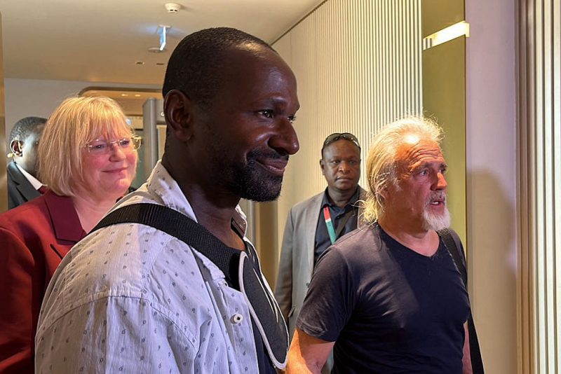 French journalist Olivier Dubois (3rd L), freed nearly two years after he was kidnapped by the Support Group for Islam and Muslims (GSIM) in Mali, and US national Jeffery Woodke (R), freed after being kidnapped in October 2016 in Niger, are seen as they arrive at the Diori Hamani International Airport in Niamey on March 20, 2023. (Photo by Souleymane AG ANARA / AFP) (Photo by SOULEYMANE AG ANARA/AFP via Getty Images)