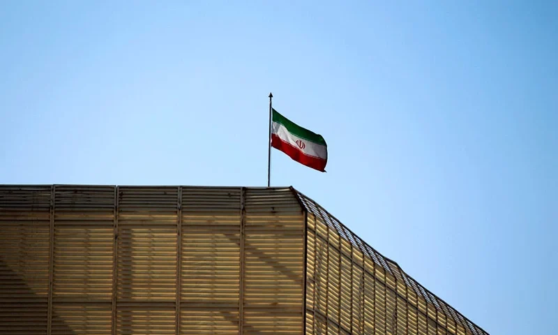 A general view shows an Iranian national flag on top of the Iranian embassy in the Yemeni capital Sanaa, on January 8, 2016. A day earlier Iran said it would protest to the UN Security Council after claiming Saudi warplanes bombed its embassy in Yemen, in a new escalation of tensions that have reverberated across the region. AFP PHOTO / MOHAMMED HUWAIS (Photo by MOHAMMED HUWAIS / AFP) (Photo by MOHAMMED HUWAIS/AFP via Getty Images)