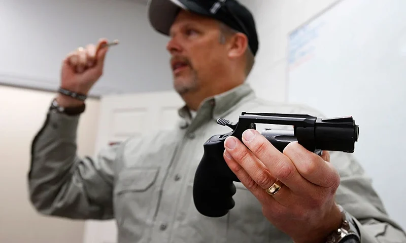 Gun instructor Mike Stilwell, demonstrates a revolver as as he teaches a packed class to obtain the Utah concealed gun carry permit, at Range Master of Utah, on January 9, 2016 in Springville, Utah. Utahs permits, available for a fee to non-residents who meet certain requirements, are among the most popular in the country because they are recognized in more than 30 states. (Photo by George Frey/Getty Images)