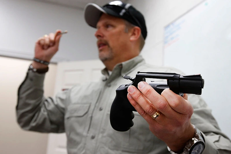 Gun instructor Mike Stilwell, demonstrates a revolver as as he teaches a packed class to obtain the Utah concealed gun carry permit, at Range Master of Utah, on January 9, 2016 in Springville, Utah. Utahs permits, available for a fee to non-residents who meet certain requirements, are among the most popular in the country because they are recognized in more than 30 states. (Photo by George Frey/Getty Images)