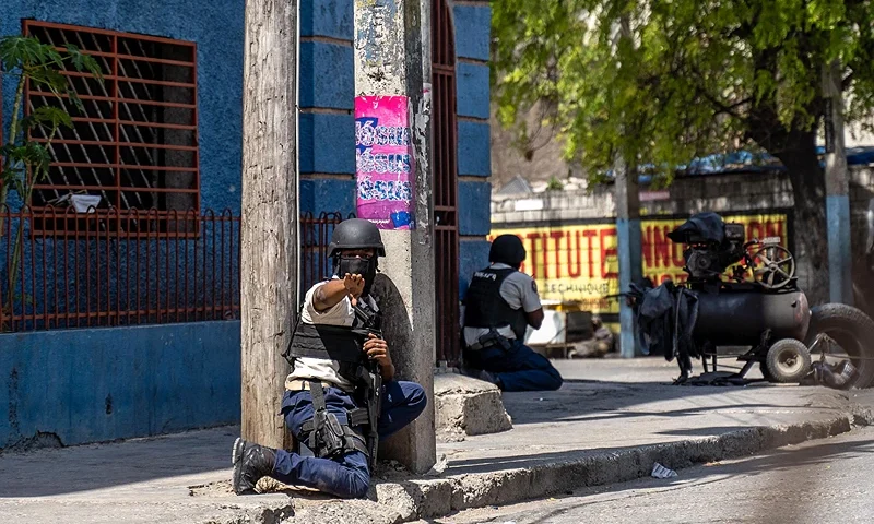 A Haitian National Police officer gestures as they attempt to repel gangs in a neighborhood near the Presidential Palace in the center of Port-au-Prince, Haiti on March 3, 2023. (Photo by Richard Pierrin / AFP) (Photo by RICHARD PIERRIN/AFP via Getty Images)