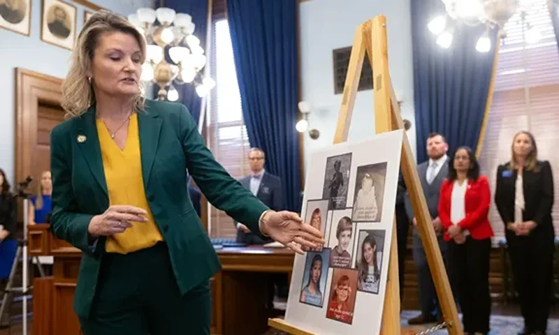 Sen. Cindy Holscher, D-Overland Park, points to a poster with seven child abuse cases during Thursday's news conference calling for a reform to the statute of limitations laws in Kansas. (Photo by Evert Nelson/TheCapital-Journal)