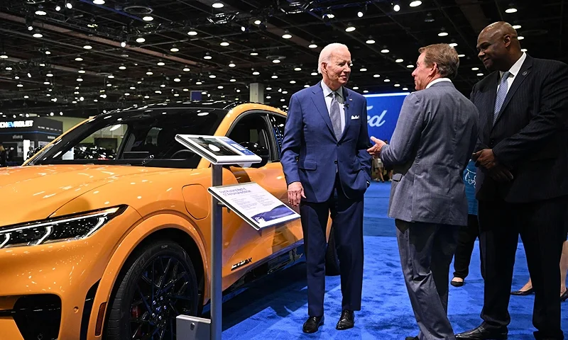 Joe Biden speaks with Ford Motor Company Executive Chairman William Clay Ford Jr. (2nd R) and President of the United Auto Workers Ray Curry during a tour of the Ford exhibit at the 2022 North American International Auto Show at Huntington Place Convention Center in Detroit, Michigan on September 14, 2022. - Biden is visiting the auto show to highlight electric vehicle manufacturing. (Photo by MANDEL NGAN/AFP via Getty Images)