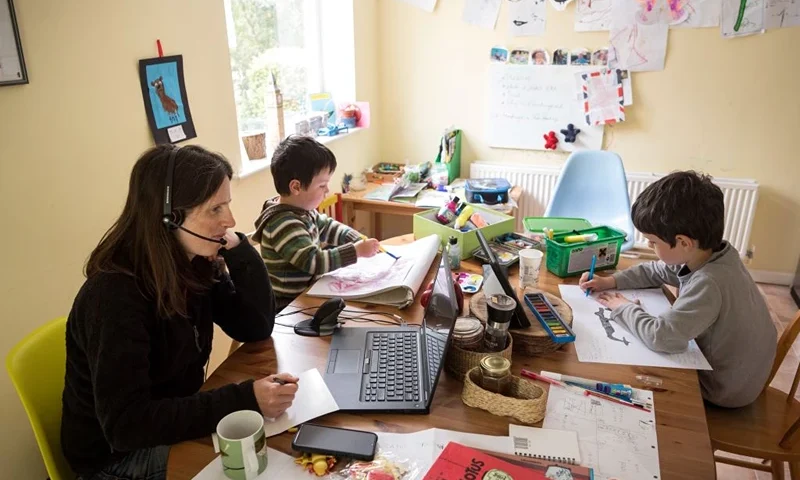Six-year-old Leo (R) and his three-year old brother Espen (C) complete homeschooling activities suggested by the online learning website of their infant school, as his mother Moira, an employee of a regional council, works from home in the village of Marsden, near Huddersfield, northern England on May 15, 2020, during the novel coronavirus COVID-19 pandemic. Leo (R), aged 6, and Espen, aged 3, undertake homeschool activities suggested by the online learning website of their infant school whilst their mother Moira, a council employee, works from home in the village of Marsden, near Huddersfield, northern England on May 15, 2020. - Prime Minister Boris Johnson has urged millions unable to work from home to return to their jobs under the new guidelines, which do not apply in Scotland, Wales or Northern Ireland. (Photo by OLI SCARFF / AFP) (Photo by OLI SCARFF/AFP via Getty Images)