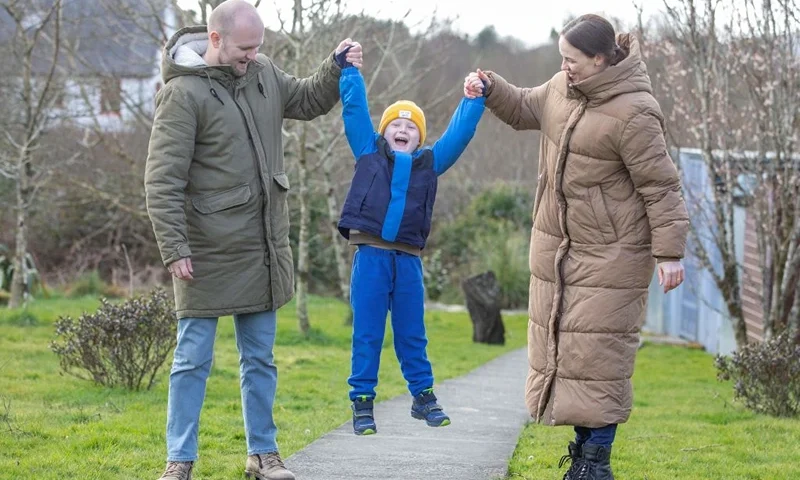 Yana (R) and Serhiy Shapoval (L) play with their five-year-old son Leonid, who suffers from leukaemia, in their new home in Ballydehob, near Cork, south west Ireland, on March 7, 2022 after fleeing Ukraine following Russia's invasion of the country. - The Shapovals escaped the war in Ukraine after doctors urged the parents of Leonid to leave the country on March 3, 2022, telling them there was no more they could do for their son. Yana and Serhiy have since learnt that the hospital, where Leonid received his chemotherapy in Kyiv, has been bombed by Russian forces. Five-year-old Leonid is now being treated in Ireland for his condition. (Photo by PAUL FAITH / AFP) (Photo by PAUL FAITH/AFP via Getty Images)