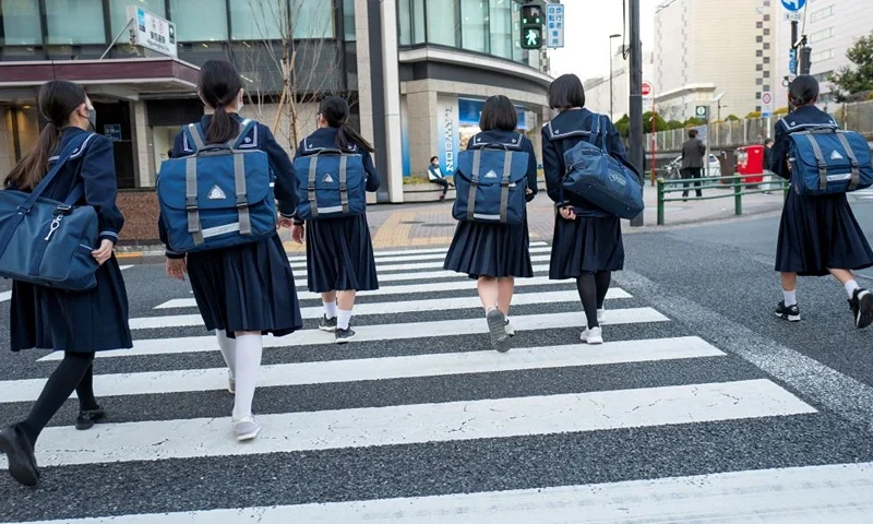 This picture taken on March 15, 2022 shows junior high school students returning home from school in Tokyo. - The percentage of teenage girls getting the HPV vaccine has been close to zero since the country's 2013 decision not to promote the jab as panic erupted over alleged side effects, but from April 1, 2022 authorities will actively recommend and share information about the vaccine, which is free for girls aged 12-16 in Japan and has been found safe in extensive trials. - TO GO WITH Japan-vaccines-health-cancer-HPV-women,FOCUS by Natsuko FUKUE (Photo by Kazuhiro NOGI / AFP) / TO GO WITH Japan-vaccines-health-cancer-HPV-women,FOCUS by Natsuko FUKUE (Photo by KAZUHIRO NOGI/AFP via Getty Images)