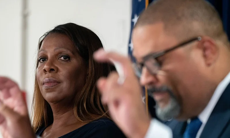 NEW YORK, NEW YORK - SEPTEMBER 08: New York State Attorney General Letitia James (L) looks on as Manhattan District Attorney Alvin Bragg speaks at a press conference after Steve Bannon, former advisor to former President Donald Trump surrendered at the NY District Attorney's office to face charges on September 08, 2022 in New York City. Bannon faces a new criminal indictment that will mirror the federal case in which he was pardoned by former President Donald Trump. He and others have been alleged to have defrauded contributors to a private $25 million fundraising effort to build a wall along the U.S.-Mexico border according. (Photo by David Dee Delgado/Getty Images)
