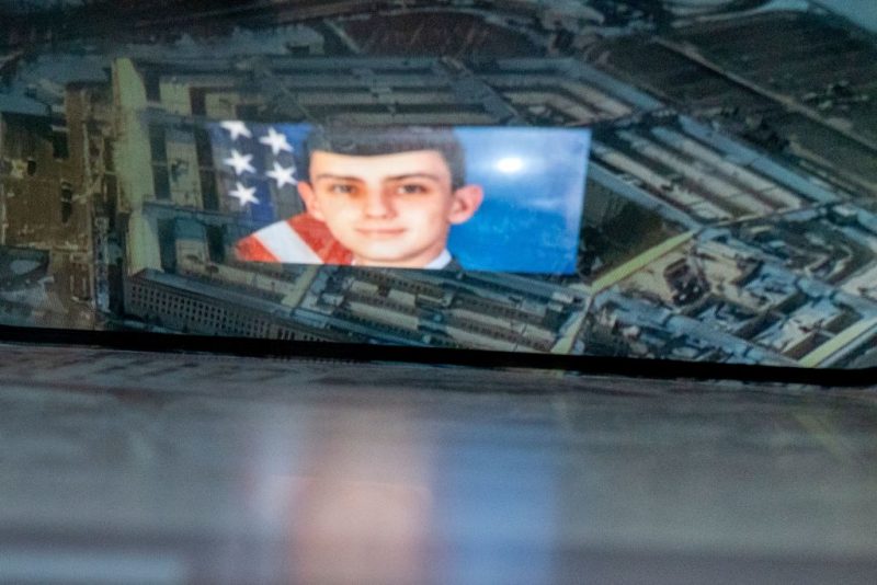This photo illustration created on April 13, 2023, shows the suspect, national guardsman Jack Teixeira, reflected in an image of the Pentagon in Washington, DC. - FBI agents on Thursday arrested a young national guardsman suspected of being behind a major leak of sensitive US government secrets -- including about the Ukraine war. US Attorney General Merrick Garland announced the arrest made 