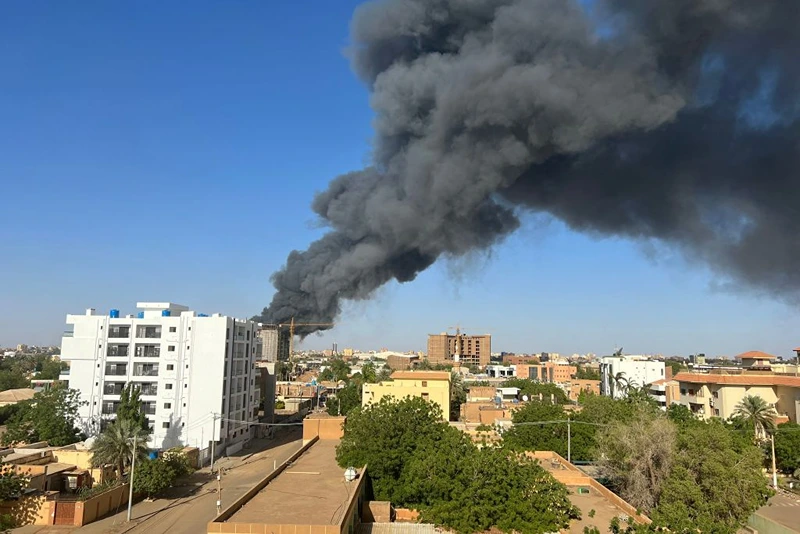 A column of smoke rises behind buildings near the airport area in Khartoum on April 19, 2023, amid fighting between the army and paramilitaries following the collapse of a 24-hour truce. (Photo by AFP) (Photo by -/AFP via Getty Images)