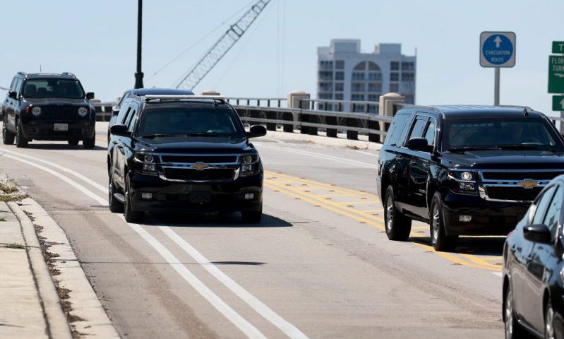PALM BEACH, FLORIDA - MARCH 23: A vehicle (to left) carrying former President Donald Trump drives near his Mar-a-Lago as he returns from golfing earlier in the day on March 23, 2023 in Palm Beach, Florida. Trump said on a social media post that he expects to be arrested in connection with an investigation into a hush-money scheme involving adult film actress Stormy Daniels and called on his supporters to protest any such move. Trump awaits a possible indictment from the Manhattan grand jury probing the hush money scheme. (Photo by Joe Raedle/Getty Images)