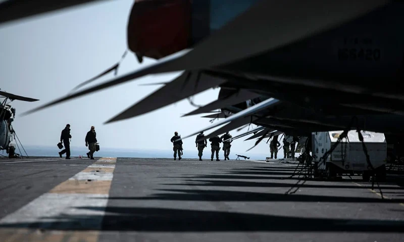 BUSAN, SOUTH KOREA - MARCH 28: Crew members walk by aircrafts aboard the U.S. Navy aircraft carrier, USS Nimitz, anchored in Busan Naval Base on March 28, 2023 in Busan, South Korea. The nuclear-powered USS aircraft carrier Nimitz docked in Busan, 390 kilometers south of Seoul, to conduct a joint Warrior Shield exercise taking place around the Korean Peninsula. The name Warrior Shield stands for the South Korea-US Alliance's ability and resolution to solidify their combined defense posture to defend South Korea. (Photo by Woohae Cho/Getty Images)