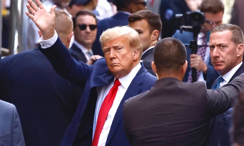 Former U.S. President Donald Trump waves as he arrives at the Manhattan Criminal Court on April 04, 2023 in New York, New York. Trump will be arraigned during his first court appearance today following an indictment by a grand jury that heard evidence about money paid to adult film star Stormy Daniels before the 2016 presidential election. With the indictment, Trump becomes the first former U.S. president in history to be charged with a criminal offense. (Photo by Kena Betancur/Getty Images)