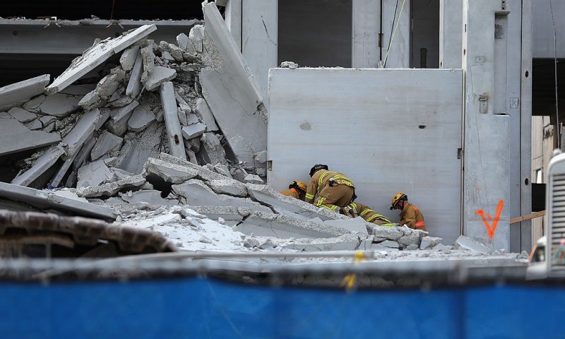 Miami-Dade Rescue workers prepare to pull a body out of the rubble of a four-story parking garage that was under construction and collapsed at the Miami Dade College’s West Campus on October 10, 2012 in Doral, Florida. Early reports indicate that one person was killed in the collapse, at least seven people injured and one person may still be trapped in the rubble. (Photo by Joe Raedle/Getty Images)