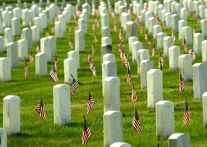 405877 03: American flags adorn each grave in Arlington National Cemetary in honor of Memorial Day May 27, 2002 in Arlington, VA. Thousands of tourists, veterans, armed services personnel, and relatives visited the cemetery in recognition of Memorial Day. (Photo by Stefan Zaklin/ Getty Images)