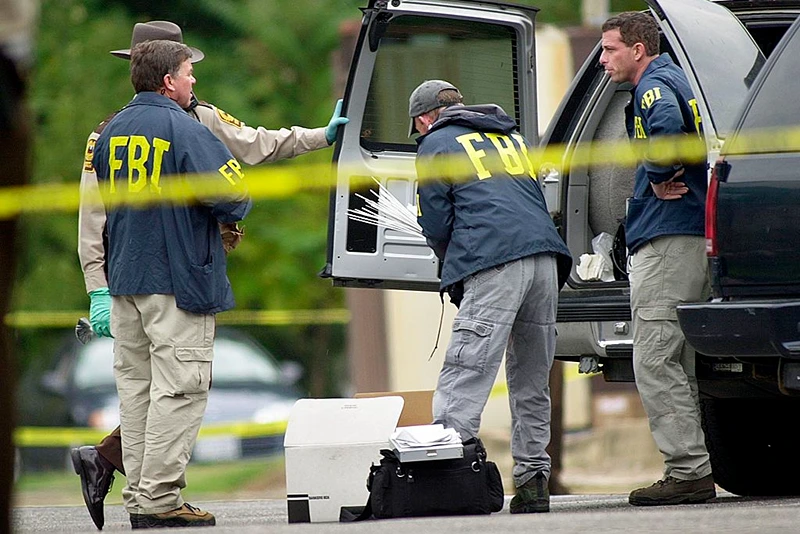 FBI agents load supplies into a truck 20 October 2002 in front of the Ponderosa Steak House where a 37 year old man was shot late 19 October in Ashland, Va. The shooting, was not fatal and has not been linked to the sniper shootings in the Washington, DC area. AFP PHOTO/Shawn THEW (Photo credit should read SHAWN THEW/AFP via Getty Images)