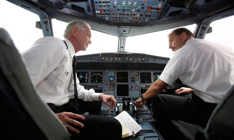 NEW YORK - OCTOBER 01: US Airway pilot Captain Chesley "Sully" Sullenberger (L) and co-pilot Jeffrey Skiles speak in the cockpit of a US Airways flight moments before take-off from LaGuardia Airport on Sullenberger's first official day back in the cockpit on October 1, 2009 in New York, New York. Sullenberger, will be back to piloting regular flights again following their emergency landing of a US Airways flight 1549 into the Hudson River after it lost power in both engines following a bird strike last January. Sullenberger and Skiles will follow the same route they took on the day of the accident to Charlotte, N.C . (Photo by Seth Wenig-Pool/Getty Images)